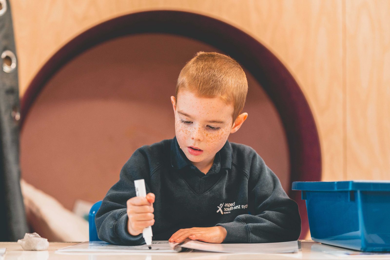 Student in a classroom completing some work